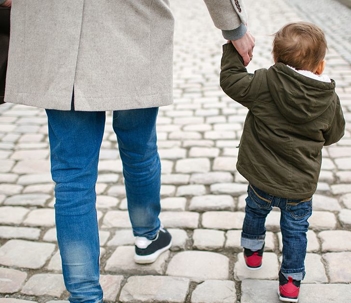 A child holding his father's hand