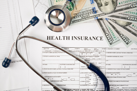 health insurance papers and money