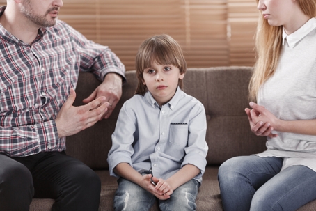 parents talking with child in between them